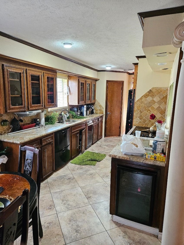 kitchen featuring light stone counters, dishwasher, crown molding, and a textured ceiling