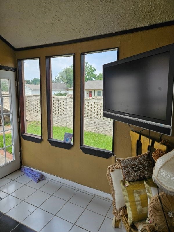 unfurnished sunroom featuring a healthy amount of sunlight and lofted ceiling