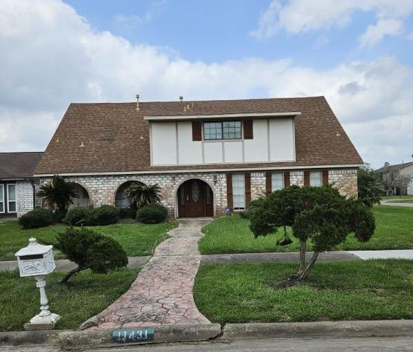 tudor house featuring a front yard