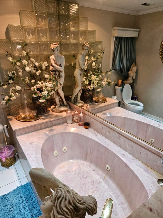 bathroom with tile patterned flooring, a washtub, toilet, and crown molding