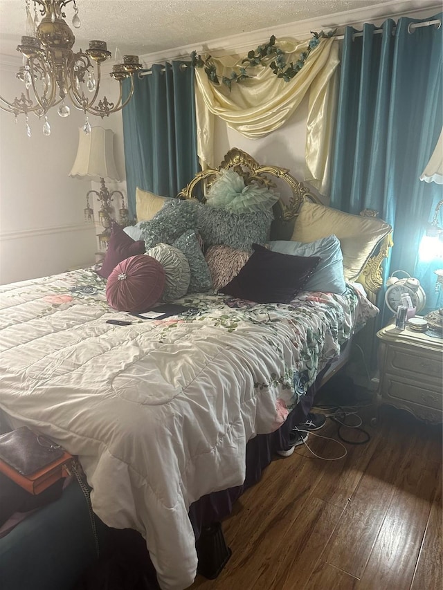 bedroom with wood-type flooring and a textured ceiling