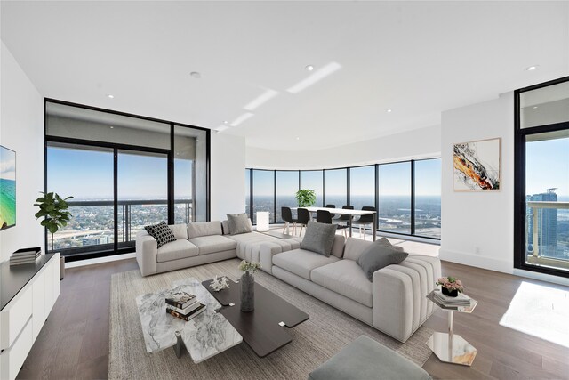 living room with a wall of windows and hardwood / wood-style flooring