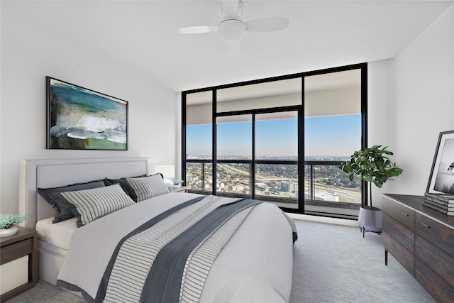 bedroom featuring floor to ceiling windows, light colored carpet, and ceiling fan