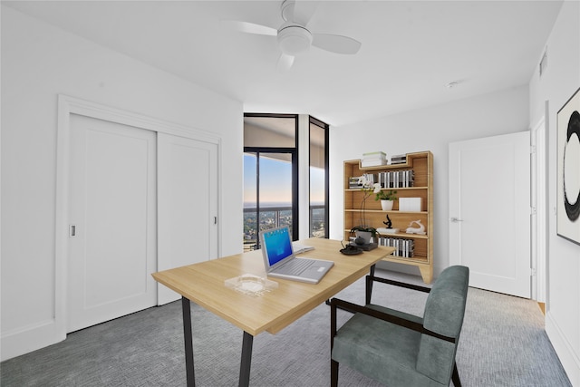 office with ceiling fan and dark carpet