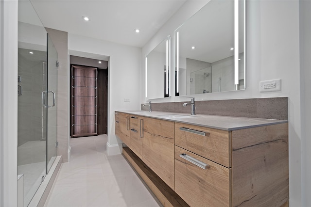 bathroom featuring tile patterned flooring, vanity, and walk in shower