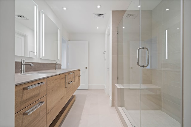 bathroom with tile patterned flooring, vanity, and an enclosed shower