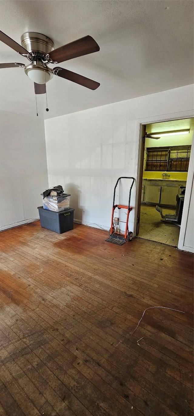 interior space with dark wood-type flooring and ceiling fan