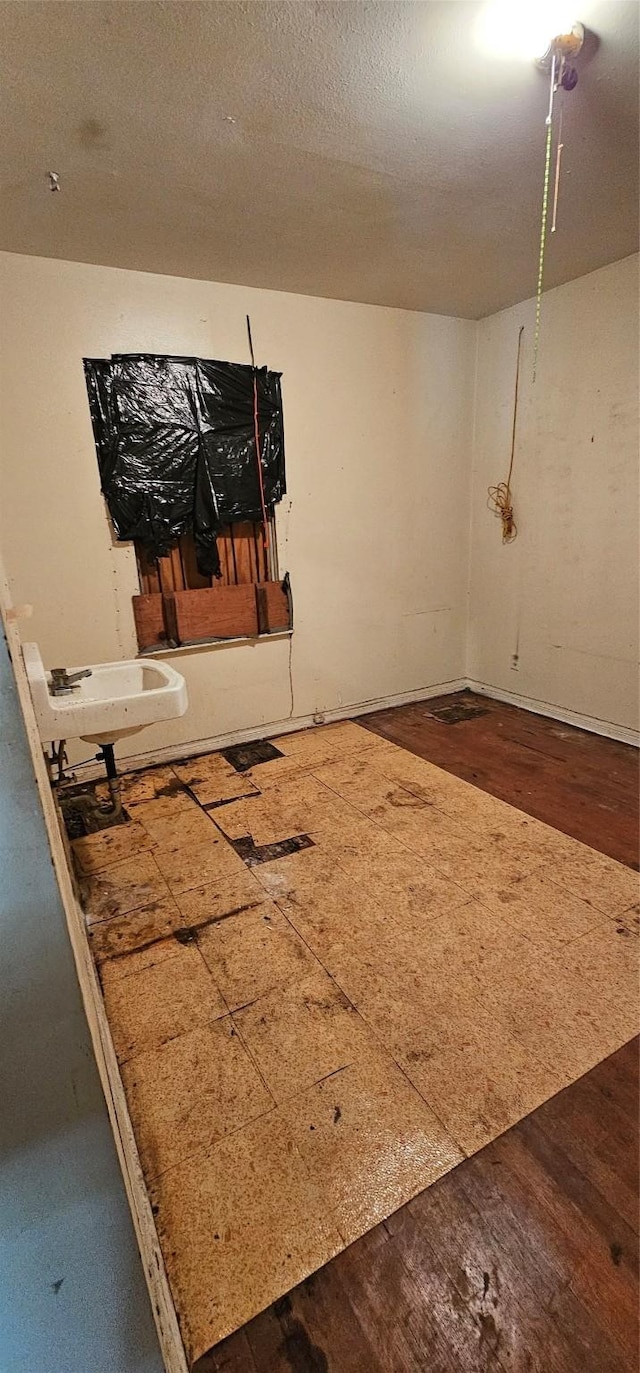 interior space with sink, hardwood / wood-style floors, and a textured ceiling