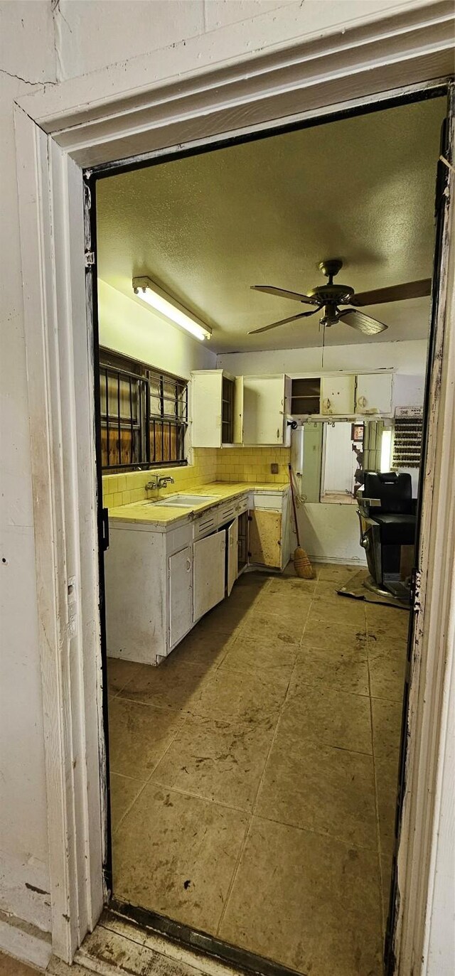 kitchen featuring ceiling fan and sink