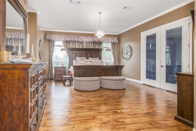 bedroom with access to outside, crown molding, french doors, and hardwood / wood-style floors