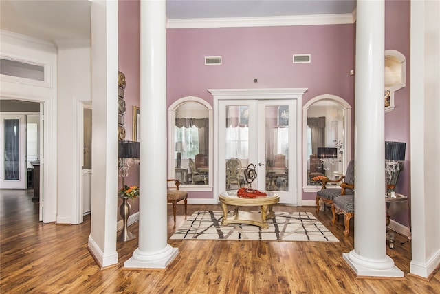 foyer entrance featuring a high ceiling, french doors, hardwood / wood-style flooring, and decorative columns