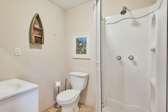 bathroom featuring a shower, tile patterned flooring, vanity, and toilet