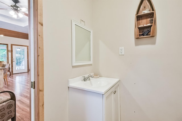 bathroom with hardwood / wood-style floors, vanity, and ceiling fan