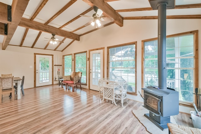 sunroom featuring vaulted ceiling with beams, a healthy amount of sunlight, and ceiling fan