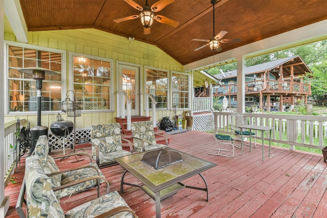 sunroom with vaulted ceiling, ceiling fan, and a healthy amount of sunlight