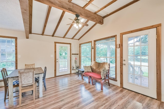 dining area featuring ceiling fan, light hardwood / wood-style flooring, beamed ceiling, high vaulted ceiling, and a textured ceiling