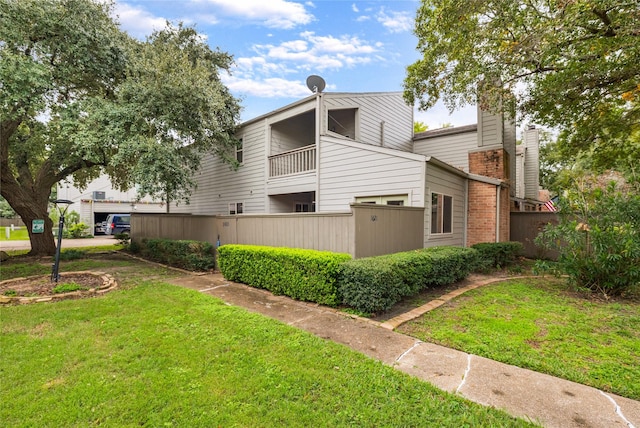 exterior space featuring a yard and fence