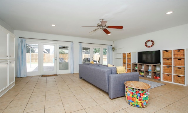 tiled living room featuring ceiling fan and french doors