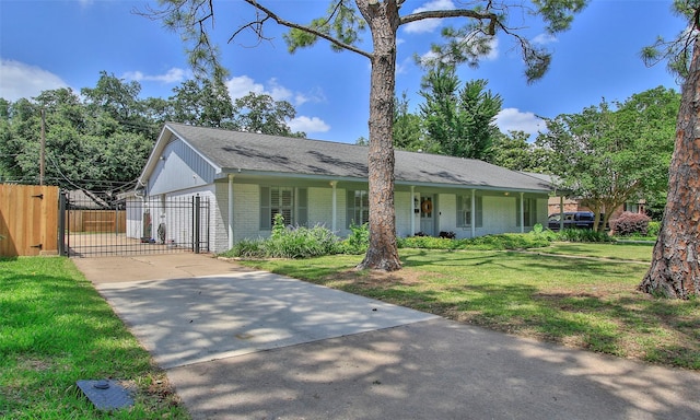 single story home featuring a front lawn, a porch, and a garage