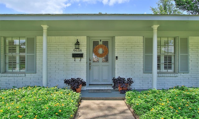 view of exterior entry featuring a porch