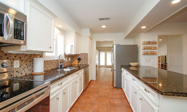 kitchen featuring white cabinets, a healthy amount of sunlight, sink, and appliances with stainless steel finishes