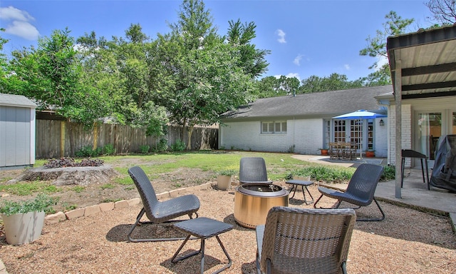 view of yard with a patio area and an outdoor fire pit