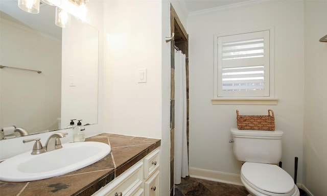 bathroom featuring vanity, toilet, and ornamental molding