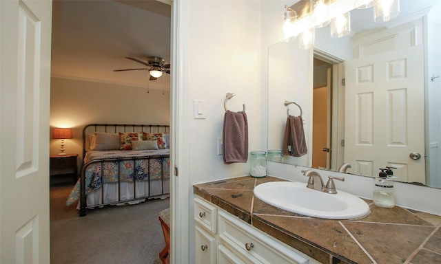 bathroom with vanity, ceiling fan, and ornamental molding