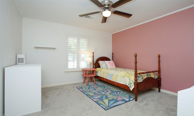 carpeted bedroom with ceiling fan and crown molding