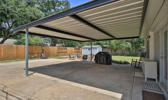 view of patio with grilling area and a storage unit