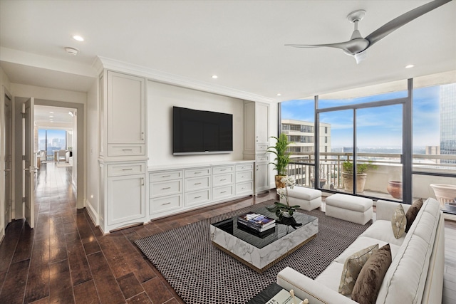 living room with expansive windows, dark hardwood / wood-style floors, and ceiling fan