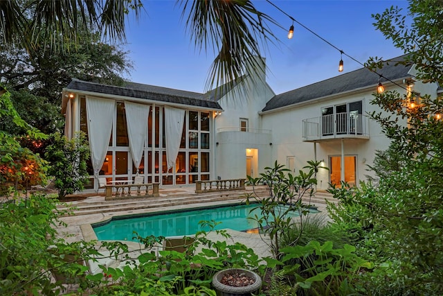 back of property with a patio area and a balcony