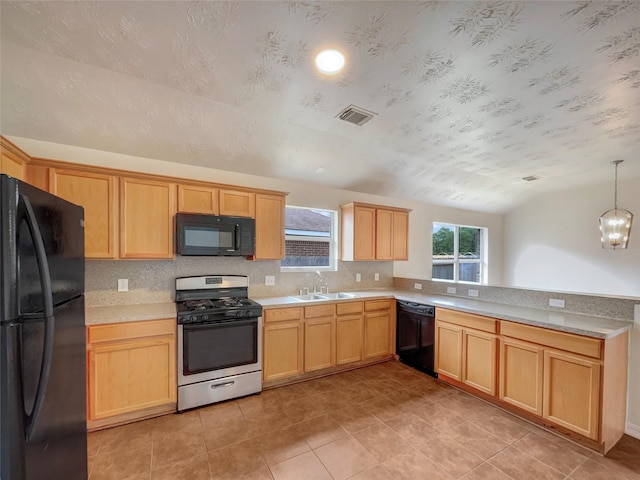 kitchen featuring sink, hanging light fixtures, an inviting chandelier, lofted ceiling, and black appliances