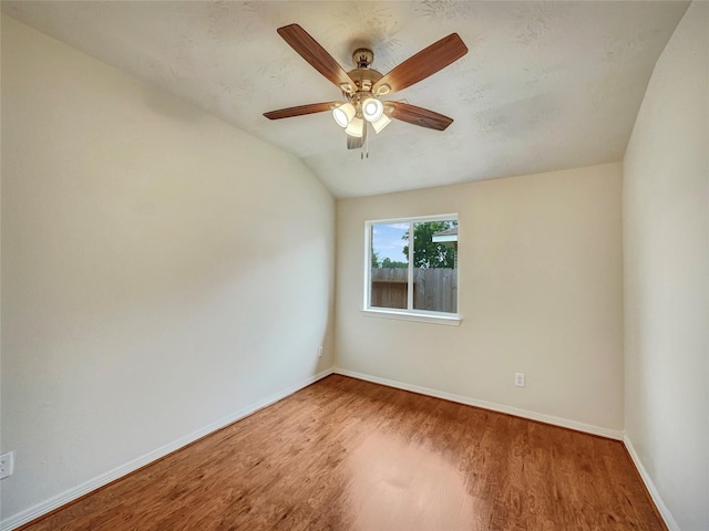 unfurnished room featuring hardwood / wood-style floors, vaulted ceiling, and ceiling fan