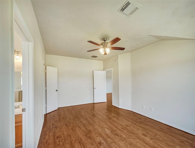 spare room with wood-type flooring, a textured ceiling, and ceiling fan