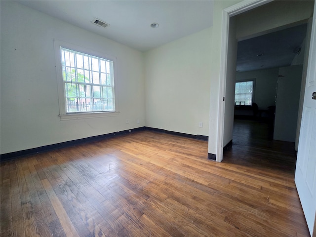 spare room featuring dark hardwood / wood-style floors