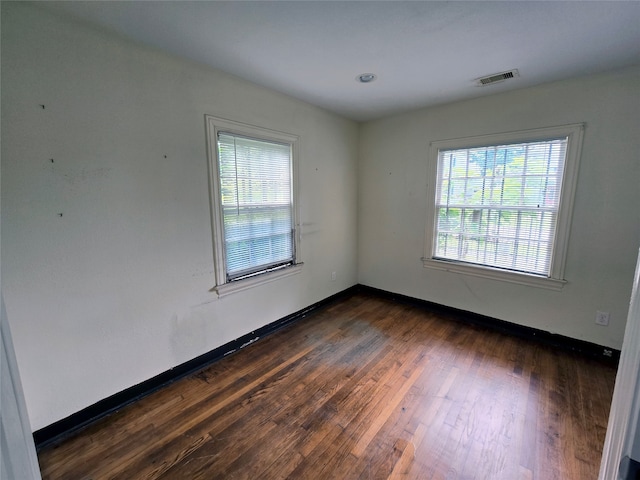 spare room featuring dark hardwood / wood-style flooring