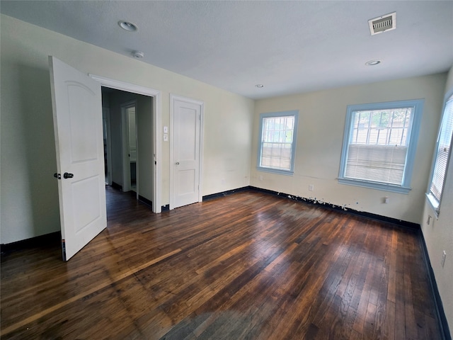 spare room featuring dark hardwood / wood-style flooring