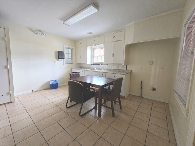 dining area featuring light tile patterned floors and sink