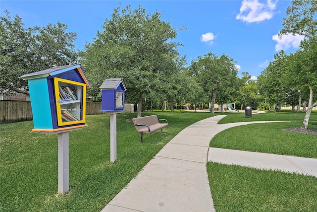 view of property's community featuring a playground and a yard