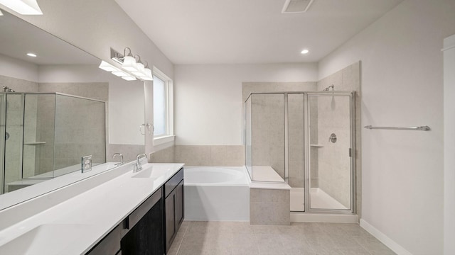 bathroom with tile patterned flooring, vanity, and shower with separate bathtub