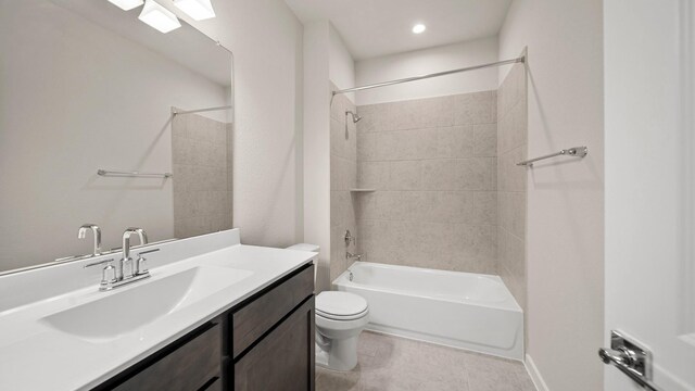 full bathroom featuring toilet, vanity, and tiled shower / bath