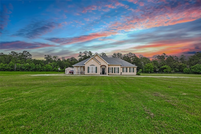 single story home with a yard