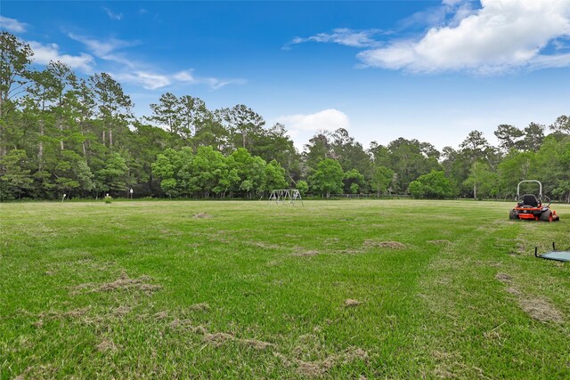 view of yard with a view of trees