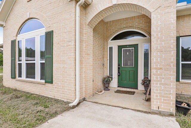 entrance to property with brick siding