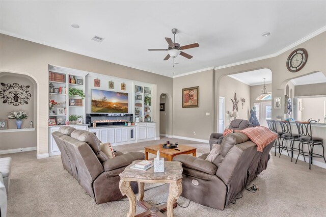 living area featuring visible vents, arched walkways, baseboards, and light colored carpet