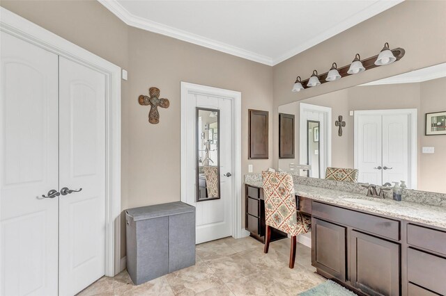 bathroom featuring ornamental molding and vanity