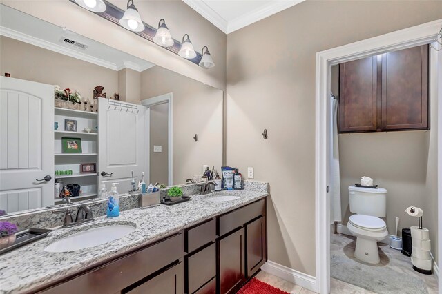 bathroom with double vanity, a sink, visible vents, and crown molding