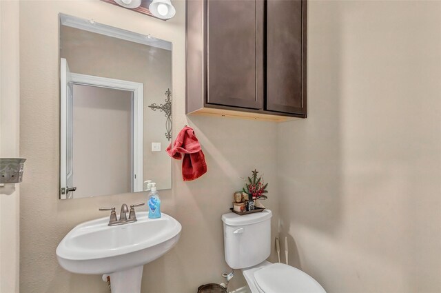 bathroom with toilet and a sink