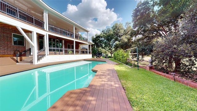 view of pool featuring a yard